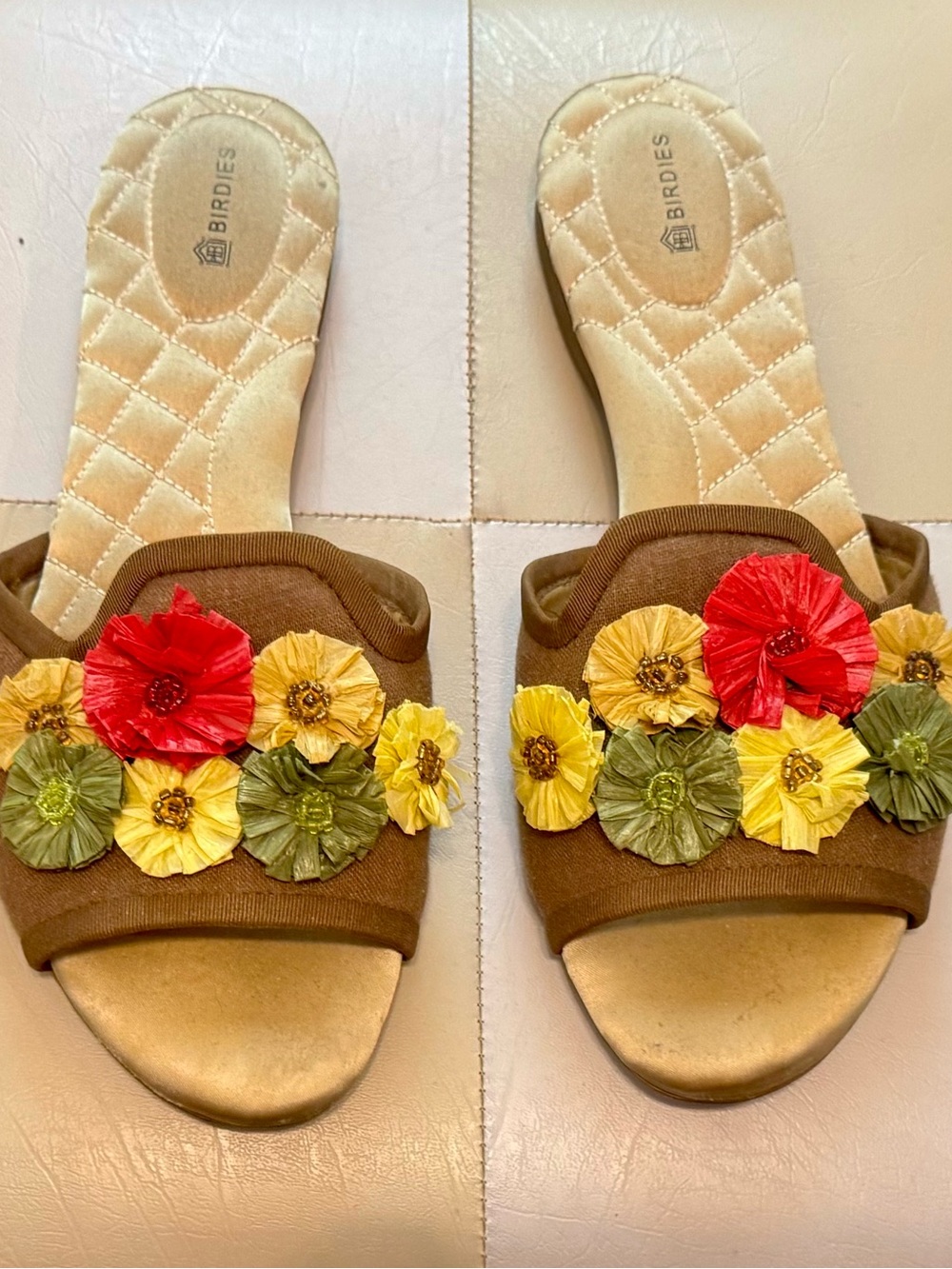 Birdies Brown Floral Appliqué Slide Sandals with Red, Yellow & Green Accents.